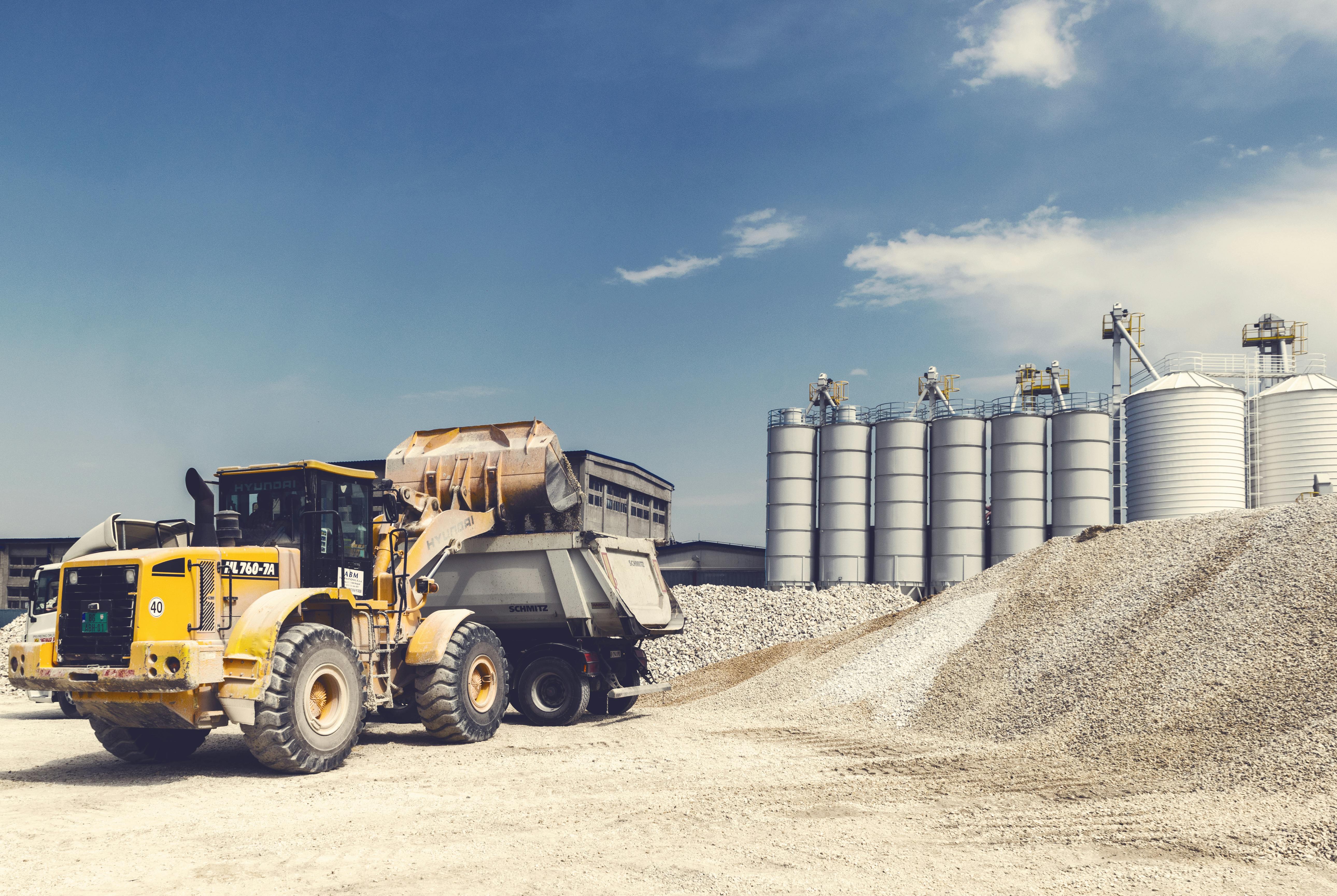 Bulk aggregate handling with loader and dump truck at a materials yard